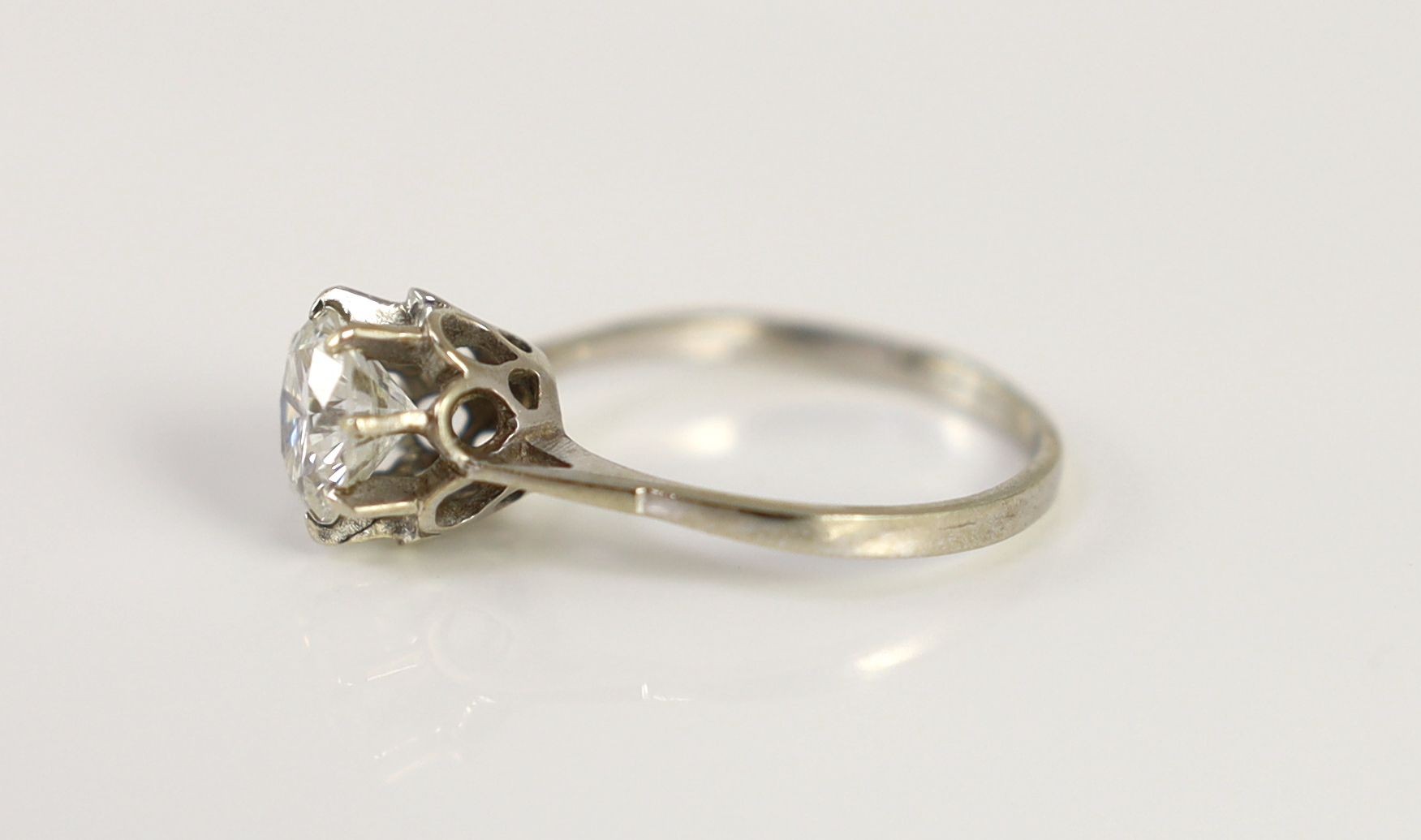 A Continental white gold and solitaire diamond set ring